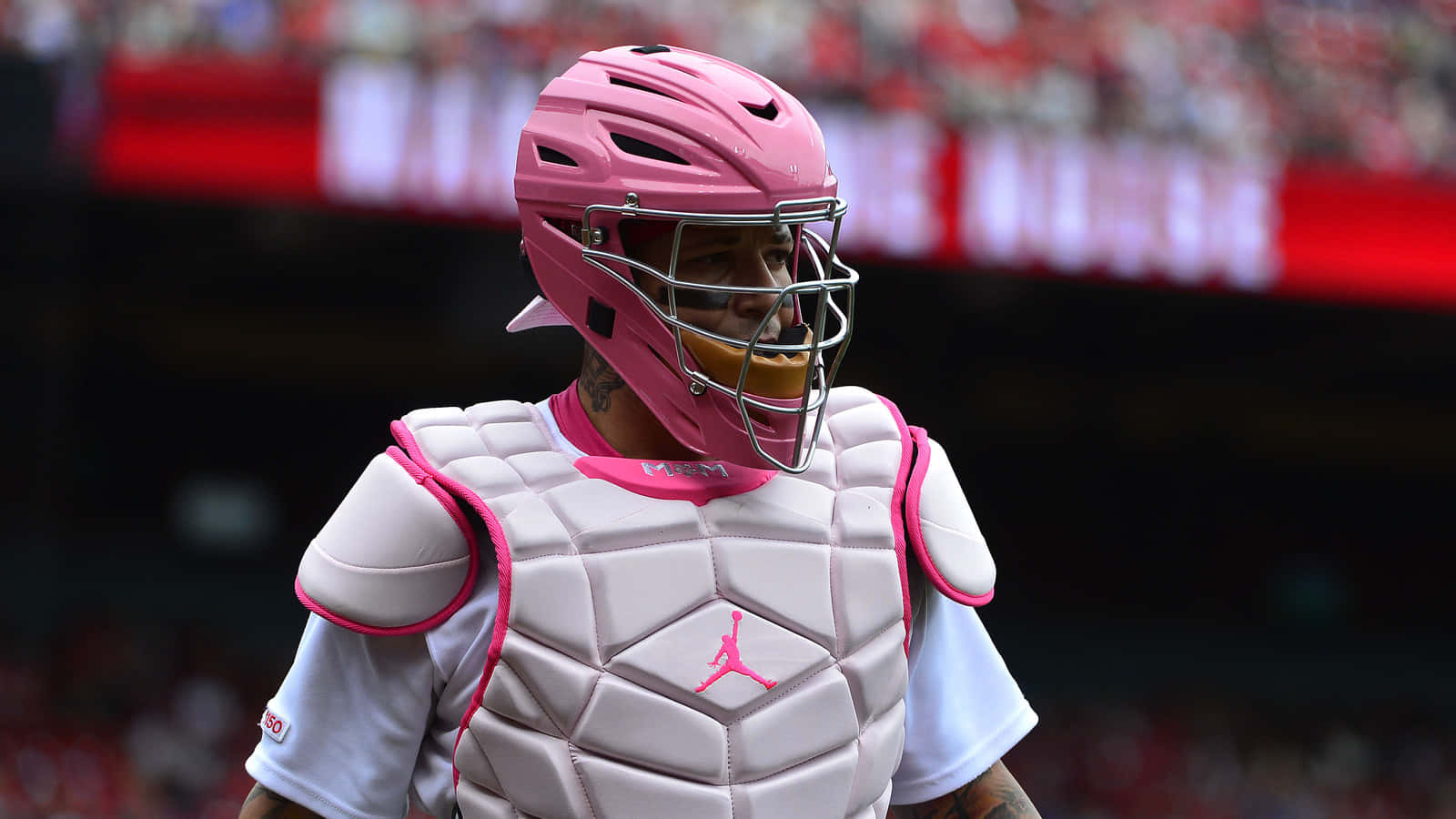 Download A Man In Pink Baseball Gear Is Standing On A Field Wallpaper