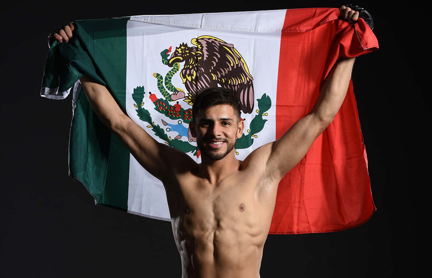 Yair Rodriguez In Action On Fight Night Wallpaper