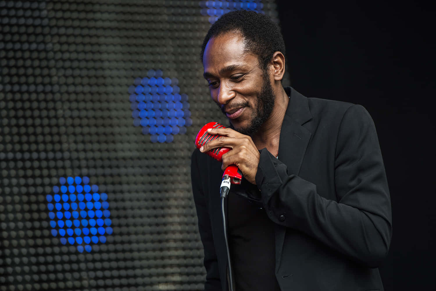 Yasiin Bey performing at an international stage Wallpaper