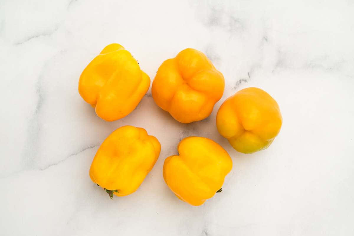 Vibrant Yellow Bell Pepper on a Wooden Surface Wallpaper