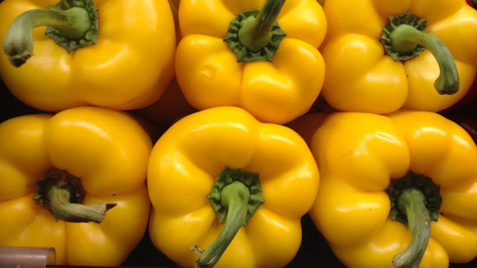 Vibrant Yellow Bell Pepper on a Dark Background Wallpaper