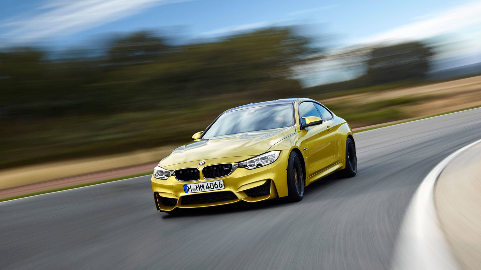 Yellow BMW M Car Speeding Up Wallpaper