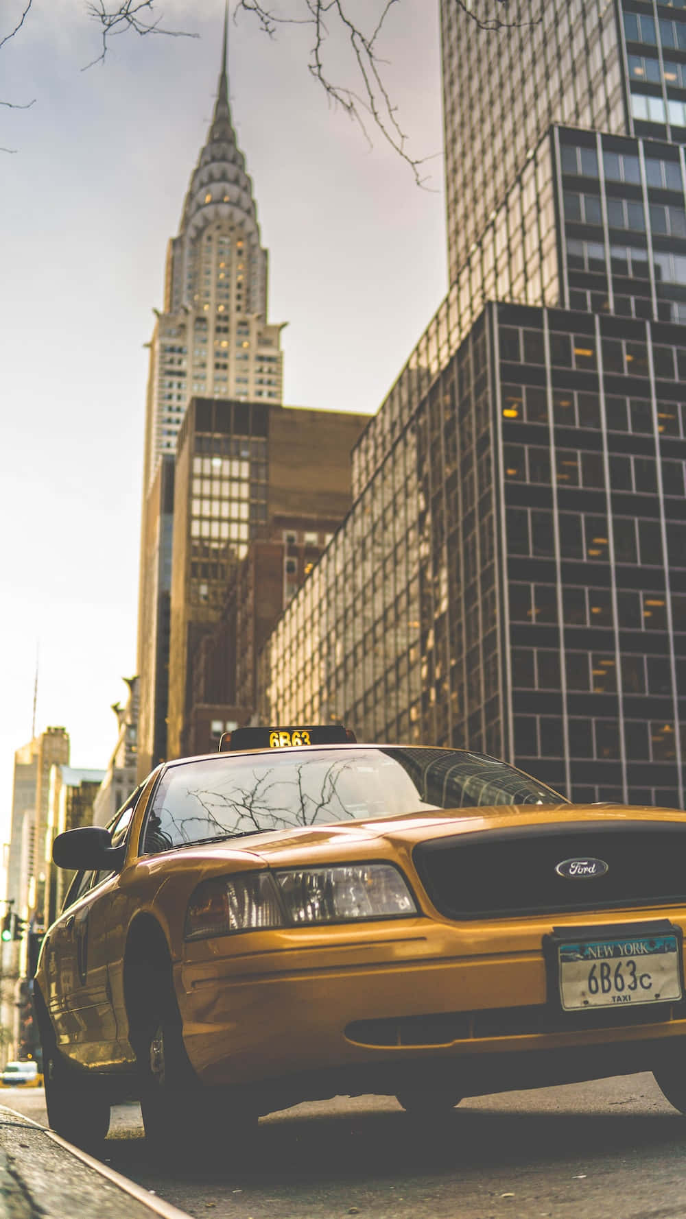 Yellow cab cruising through the city streets Wallpaper