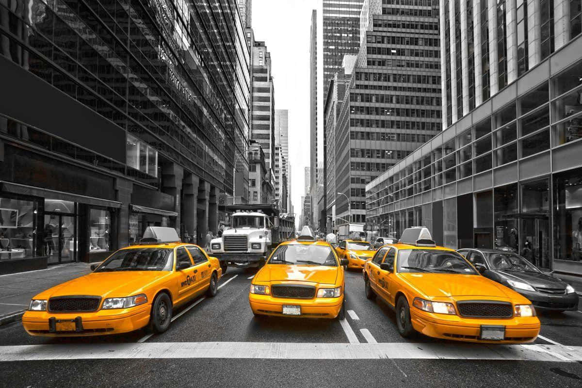 A vibrant yellow cab on a bustling city street Wallpaper