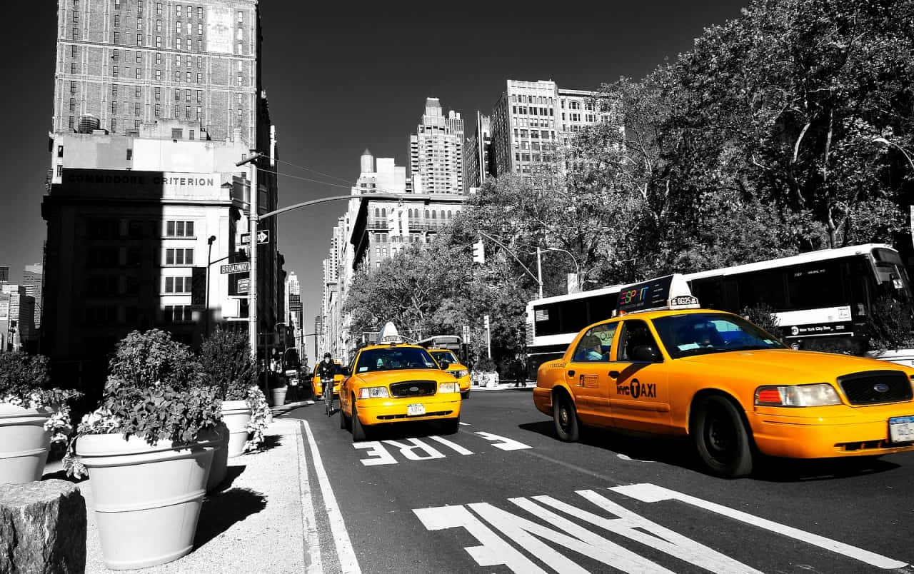 Vibrant Yellow Cab on City Street Wallpaper