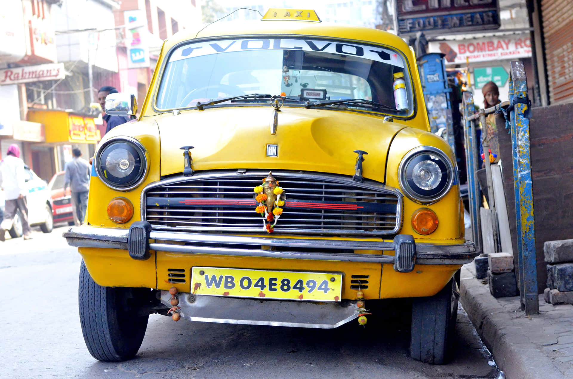 Iconic Yellow Cab cruising through the city streets Wallpaper