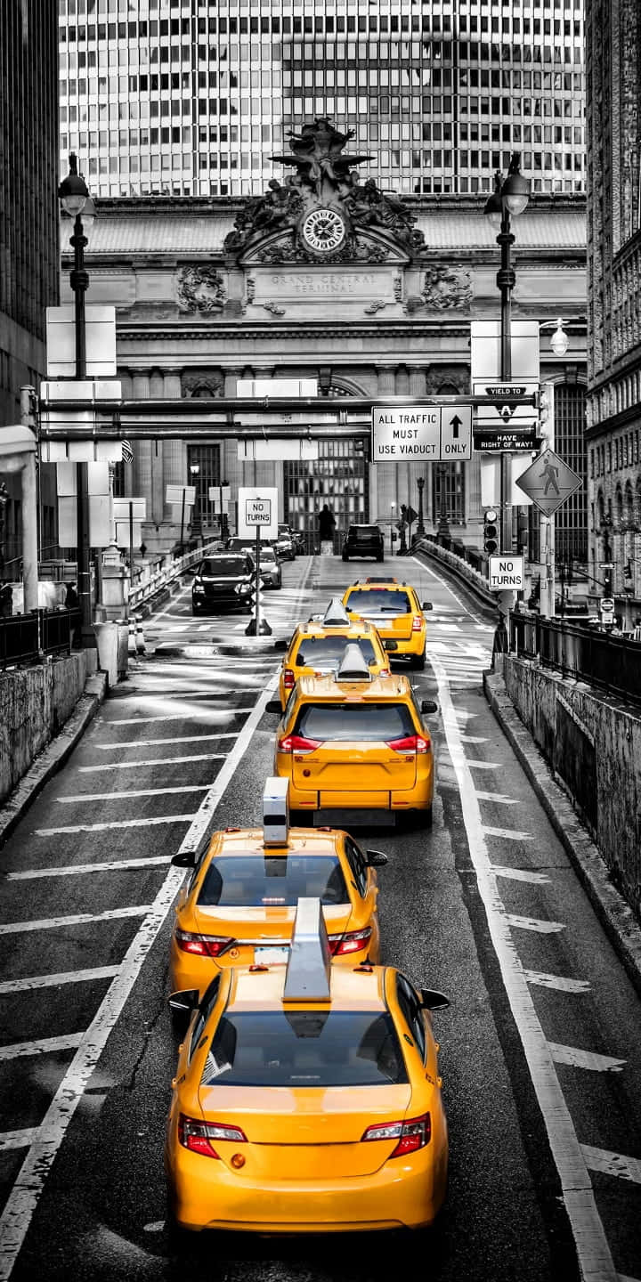Yellow cab in city traffic Wallpaper