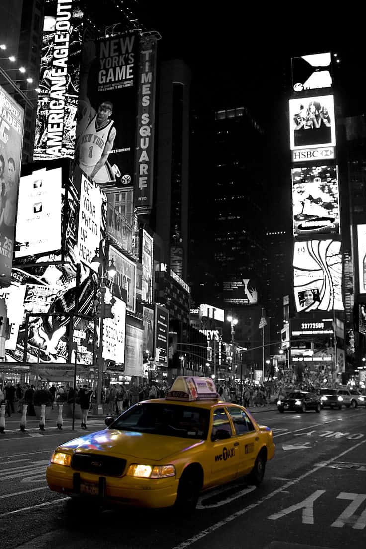 Yellow Cab on a Busy City Street Wallpaper