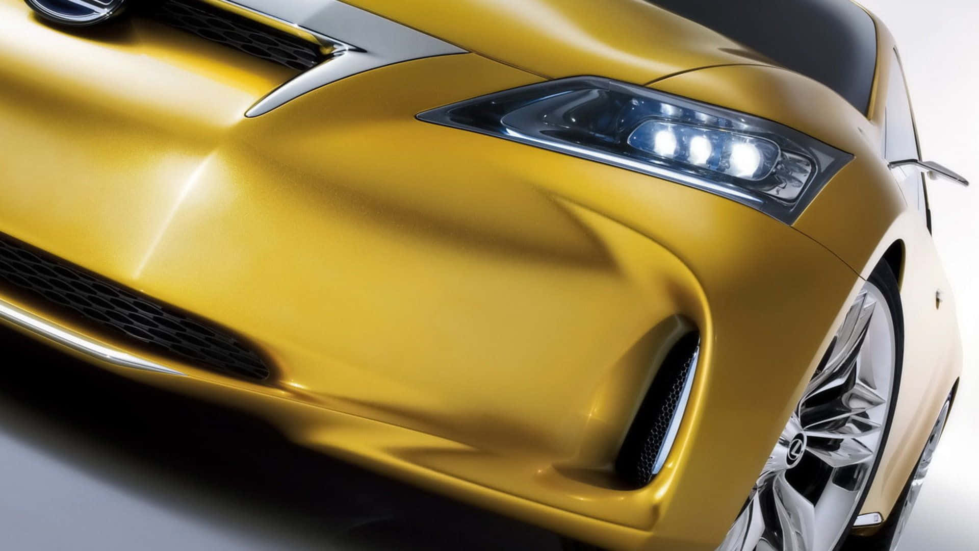 Sleek Yellow Car in Action Wallpaper