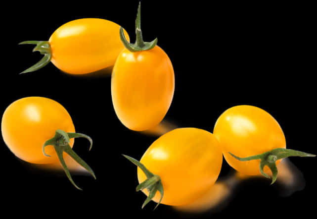 Yellow Cherry Tomatoeson Black Background PNG