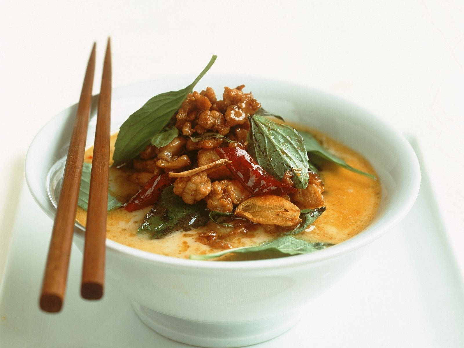 Yellow Curry Topped With Basil Leaves And Red Chili Wallpaper