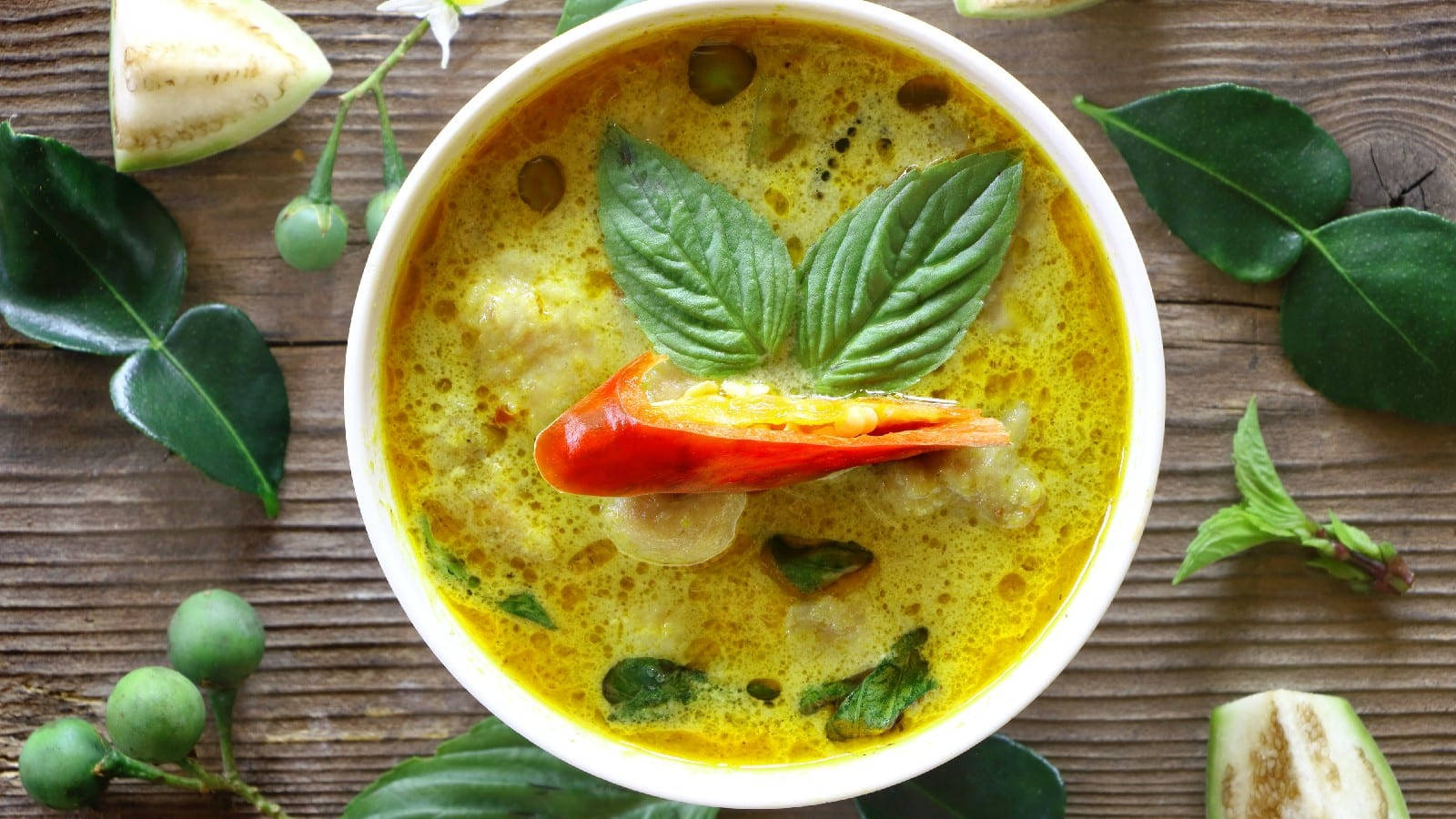 Yellow Curry With Basil Leaves And Red Chili Wallpaper