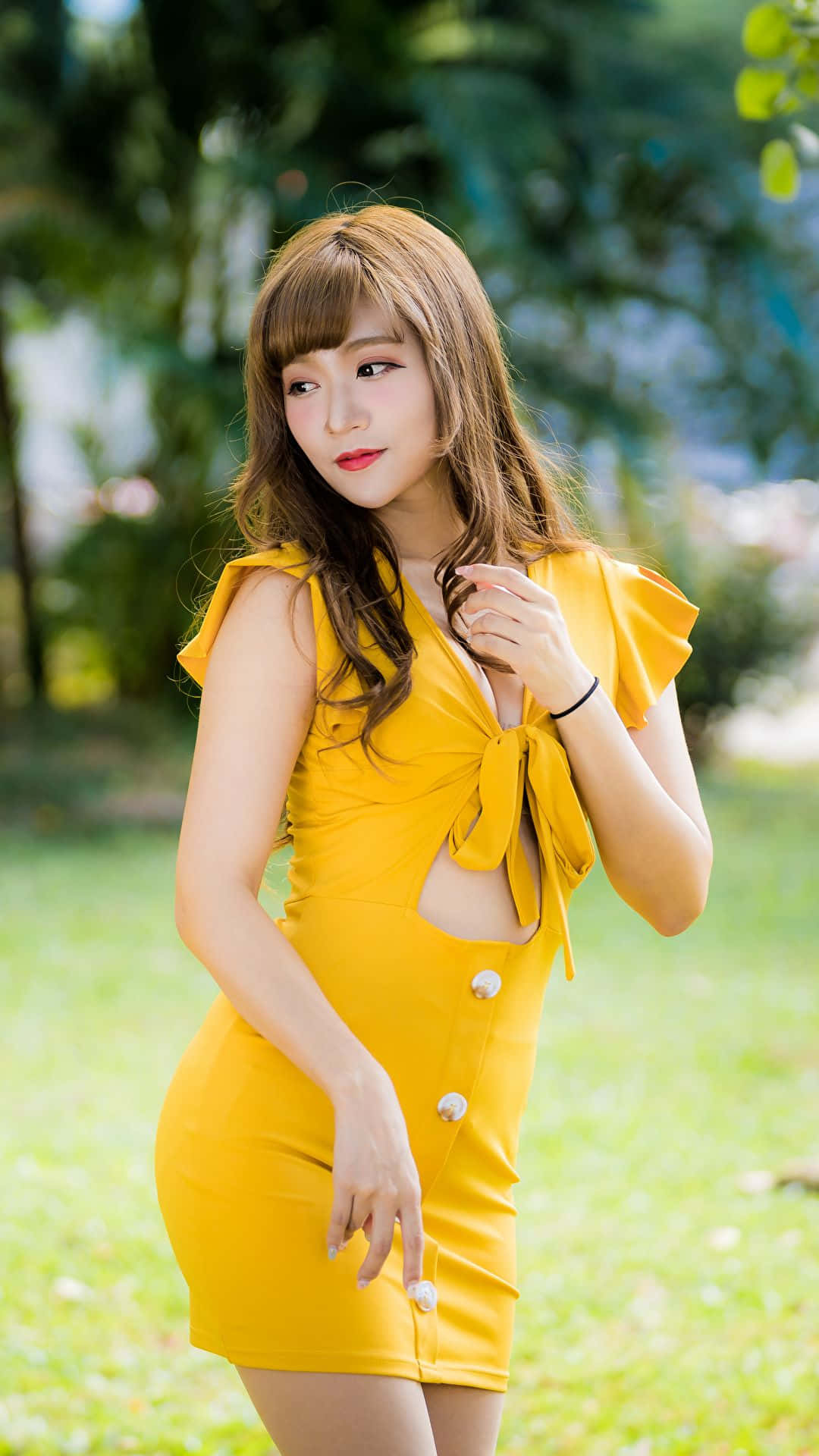 Elegant Woman in a Stunning Yellow Dress Wallpaper