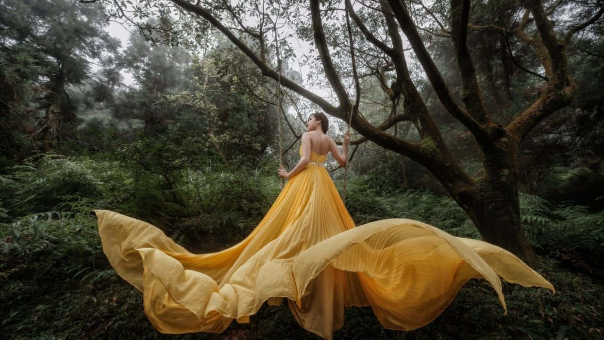 Elegant Woman in a Vibrant Yellow Dress Wallpaper