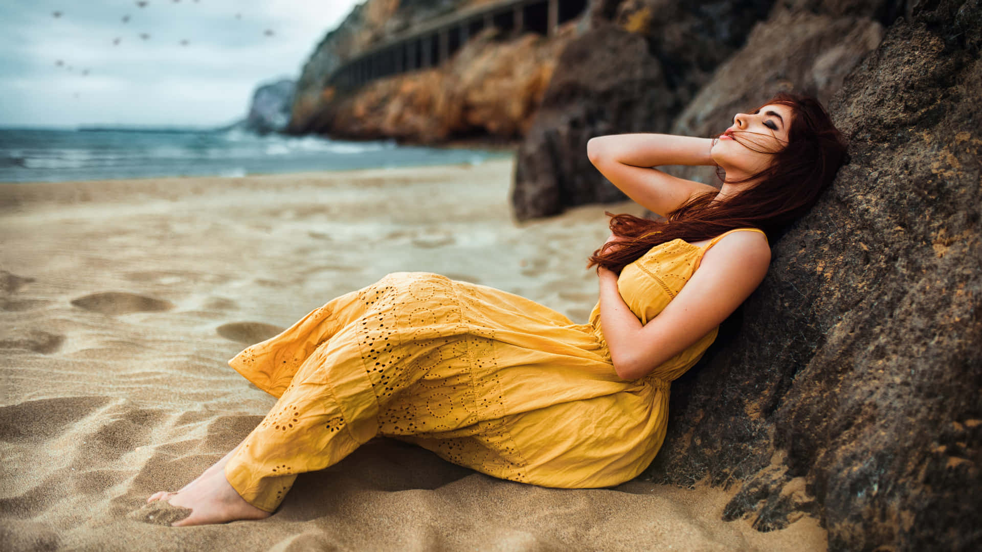 Radiant Woman in a Flowing Yellow Dress Wallpaper