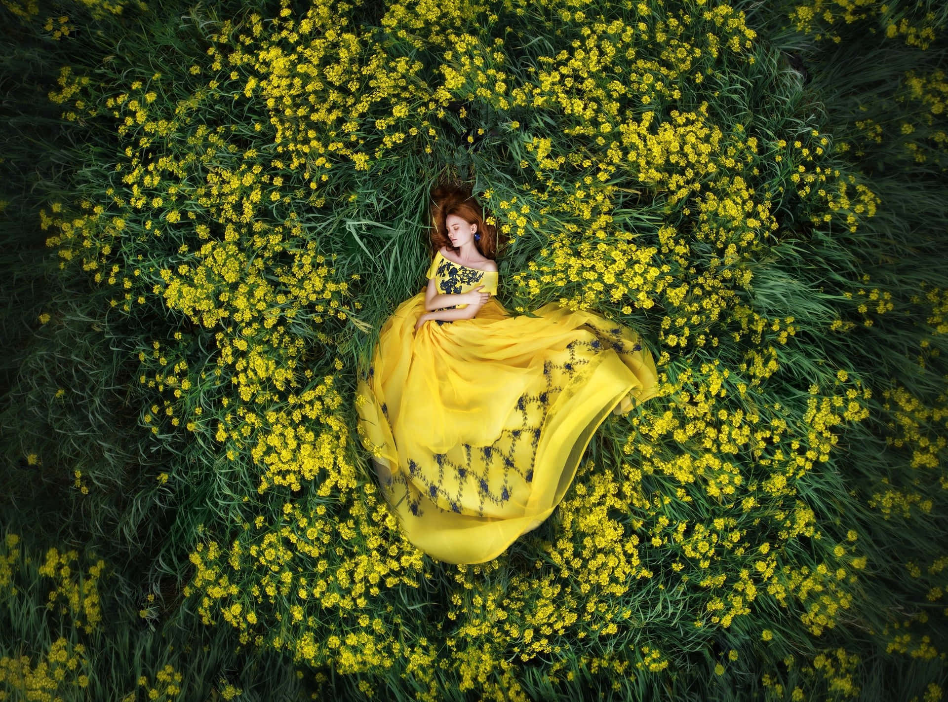 Elegant Woman in a Flowing Yellow Dress Wallpaper