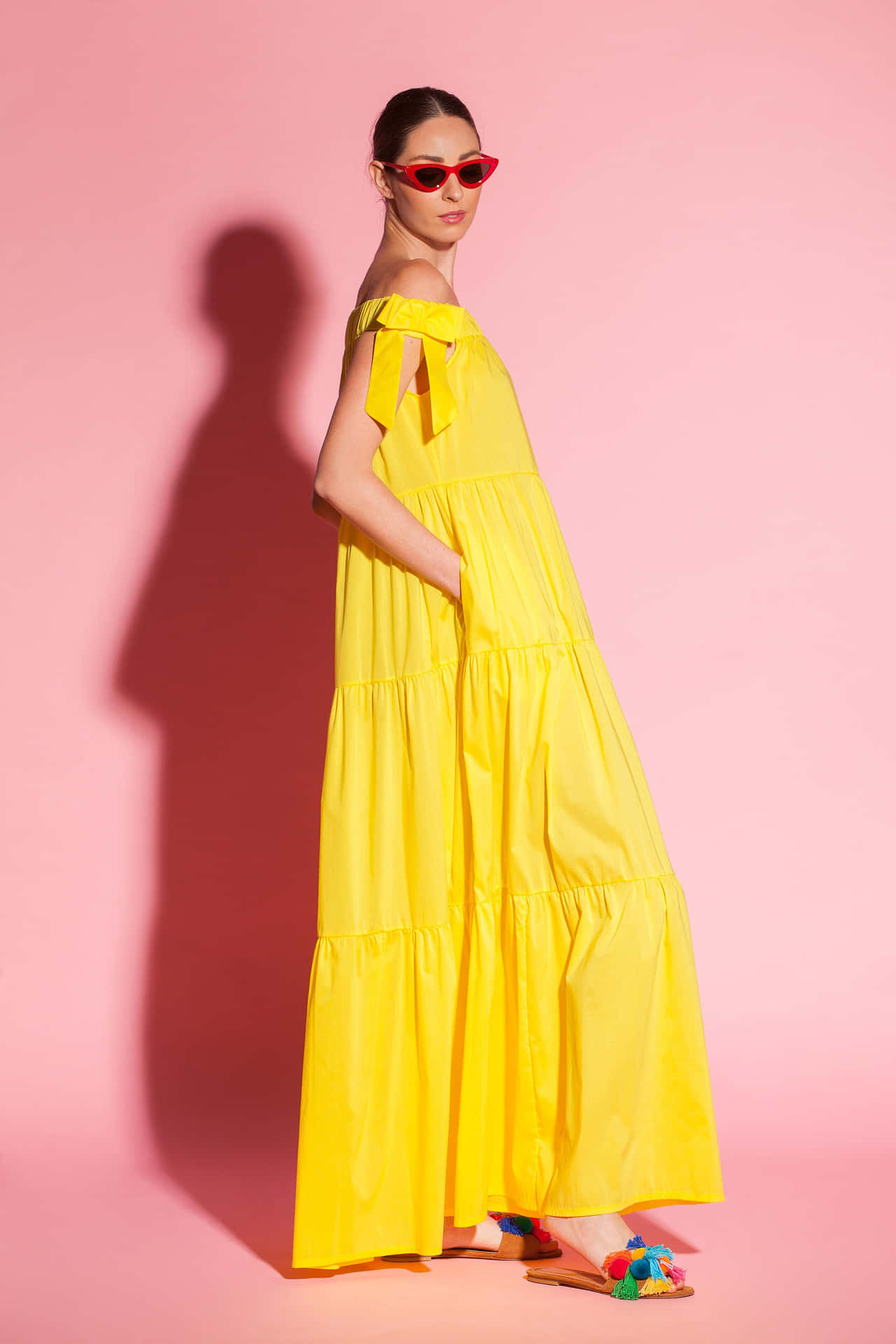 Glamorous woman in vibrant yellow haute couture outfit Wallpaper