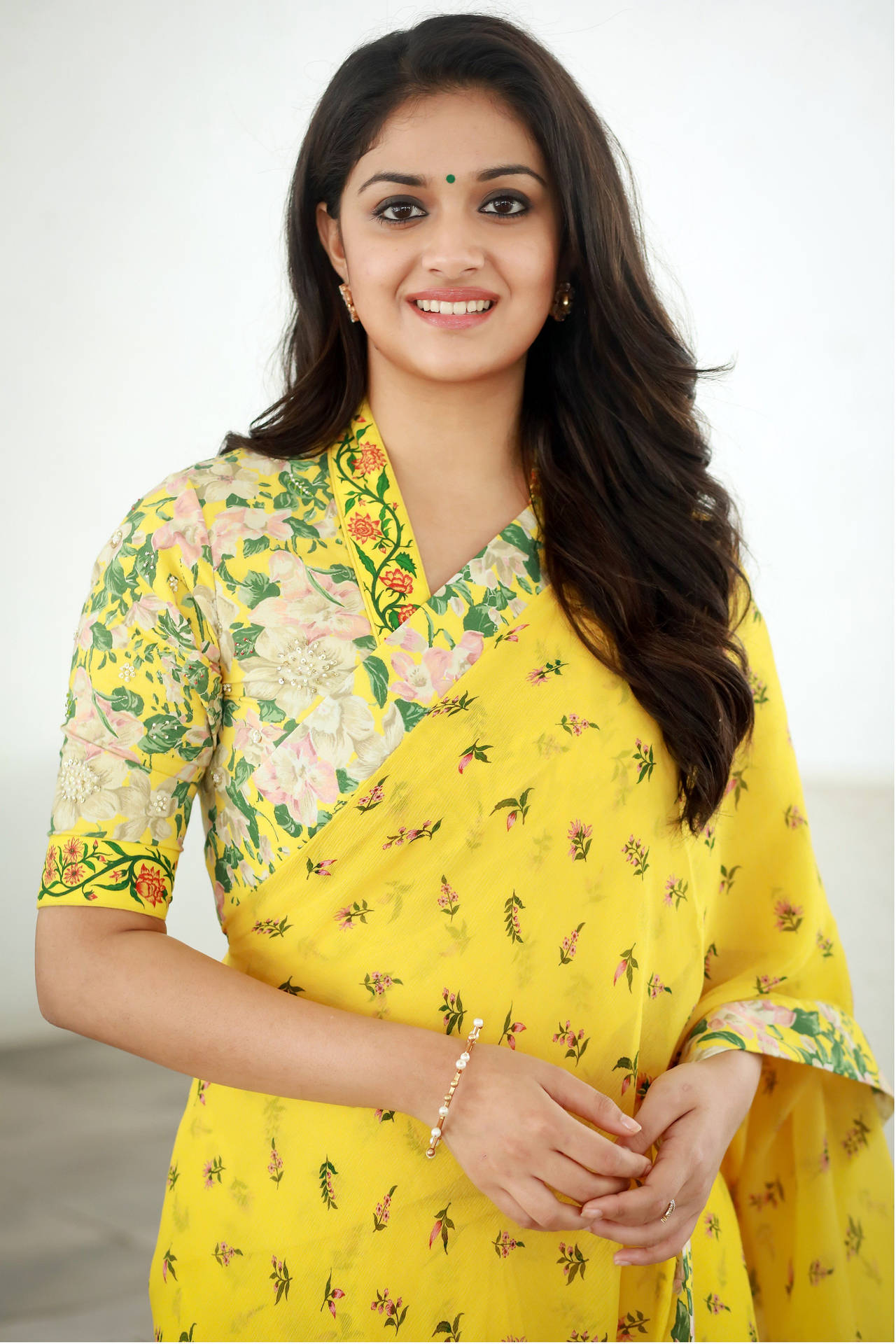 Vibrant Elegance - Keerthi Suresh in a Stunning Yellow Floral Saree Wallpaper