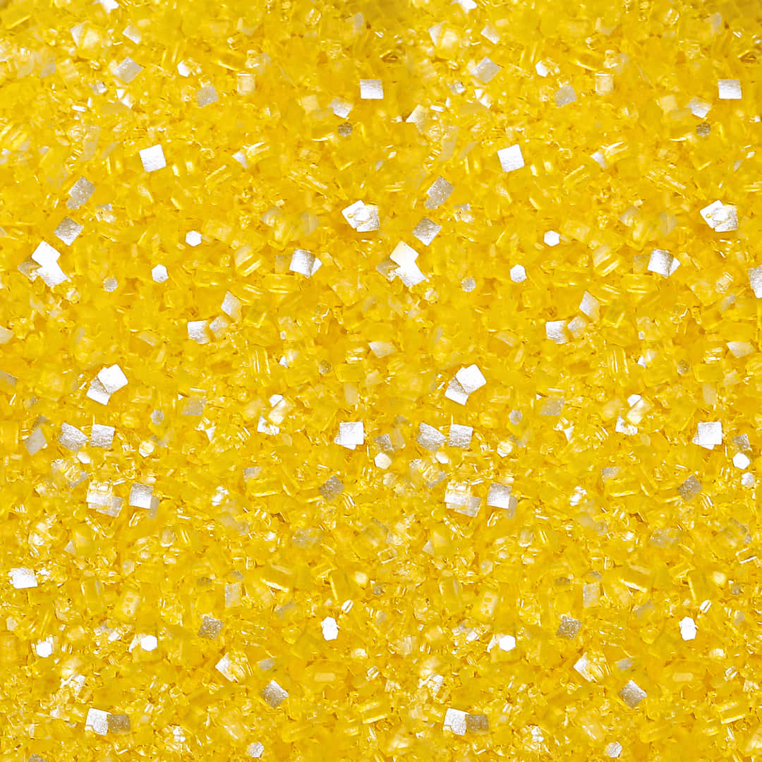 A Close Up Of A Yellow And Silver Glitter Wallpaper