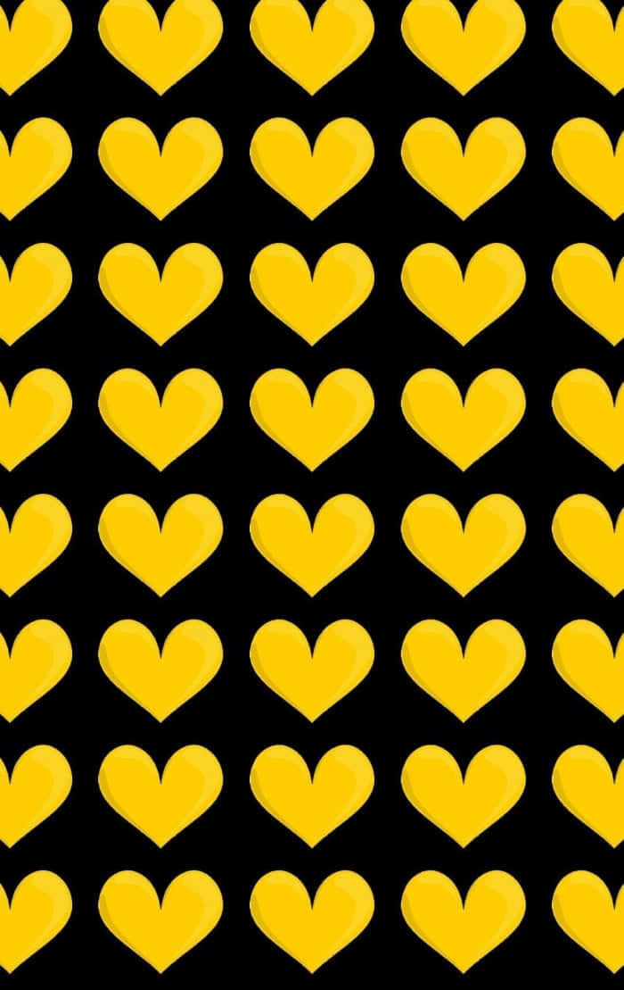 A Radiant Yellow Heart on a Subtle Black Background Wallpaper