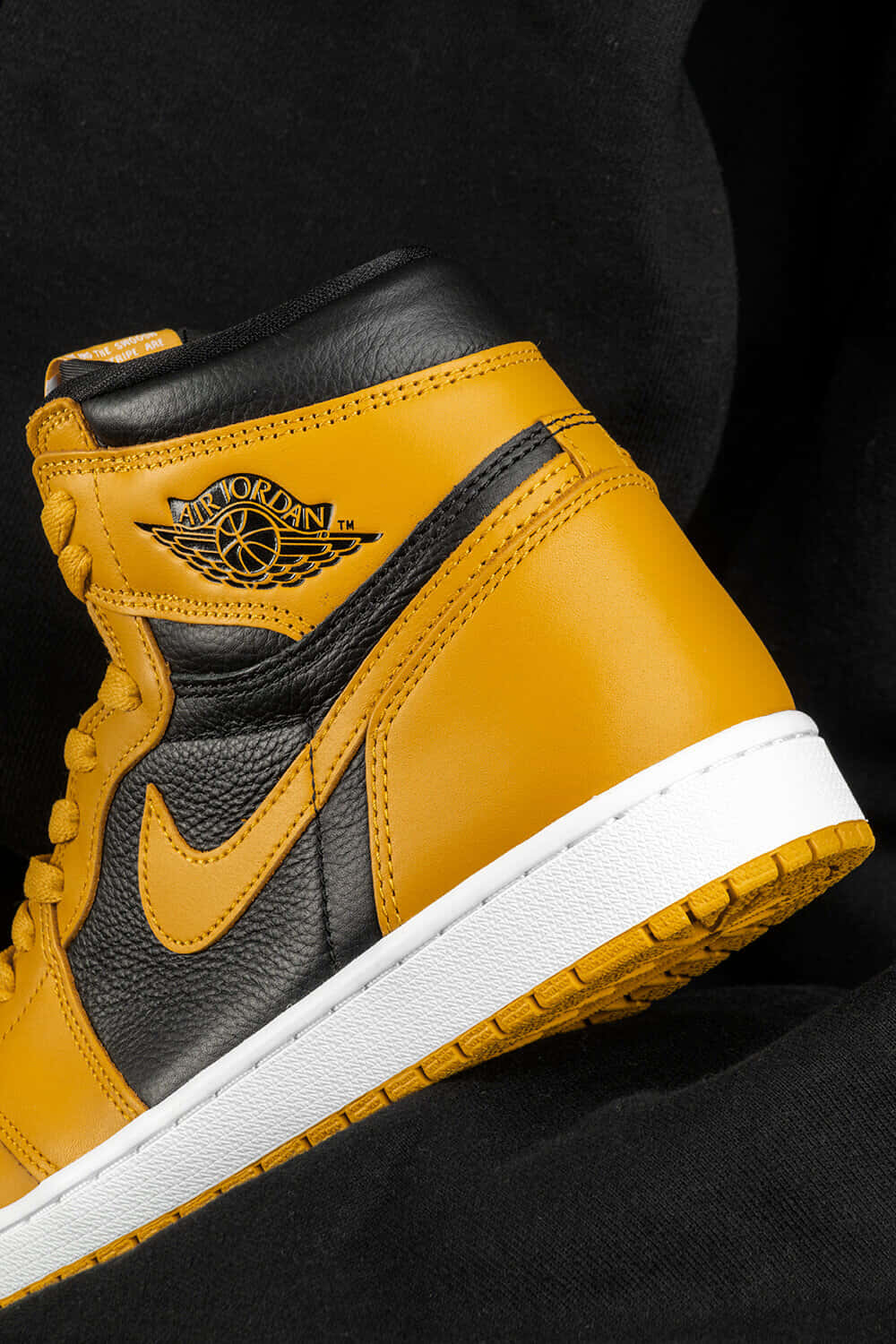 "Walk into the game with style and confidence with a pair of yellow Jordan sneakers." Wallpaper