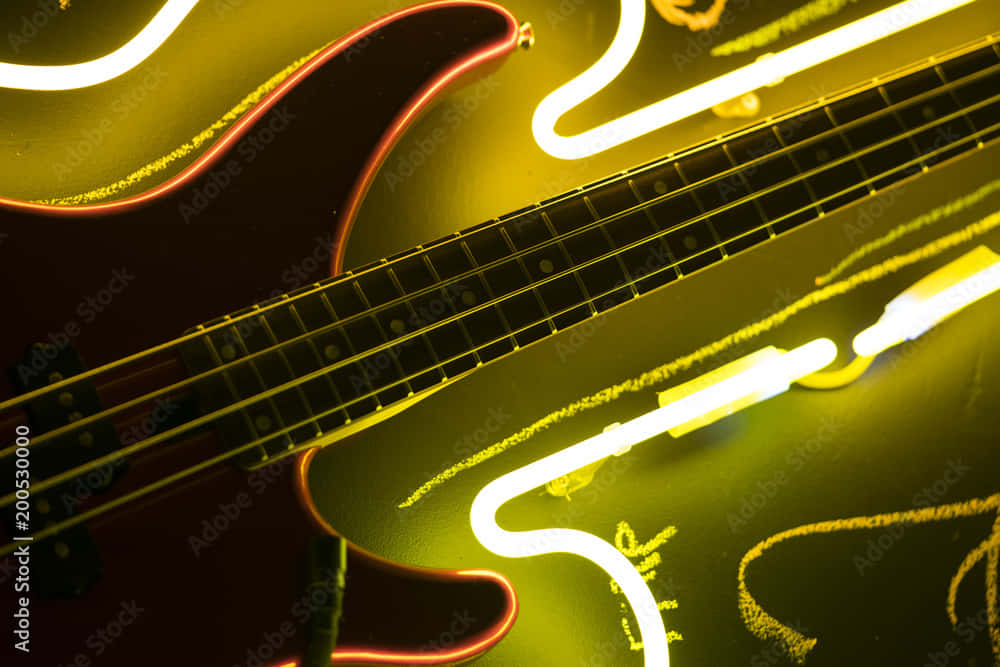 A Bass Guitar With Neon Lights Wallpaper