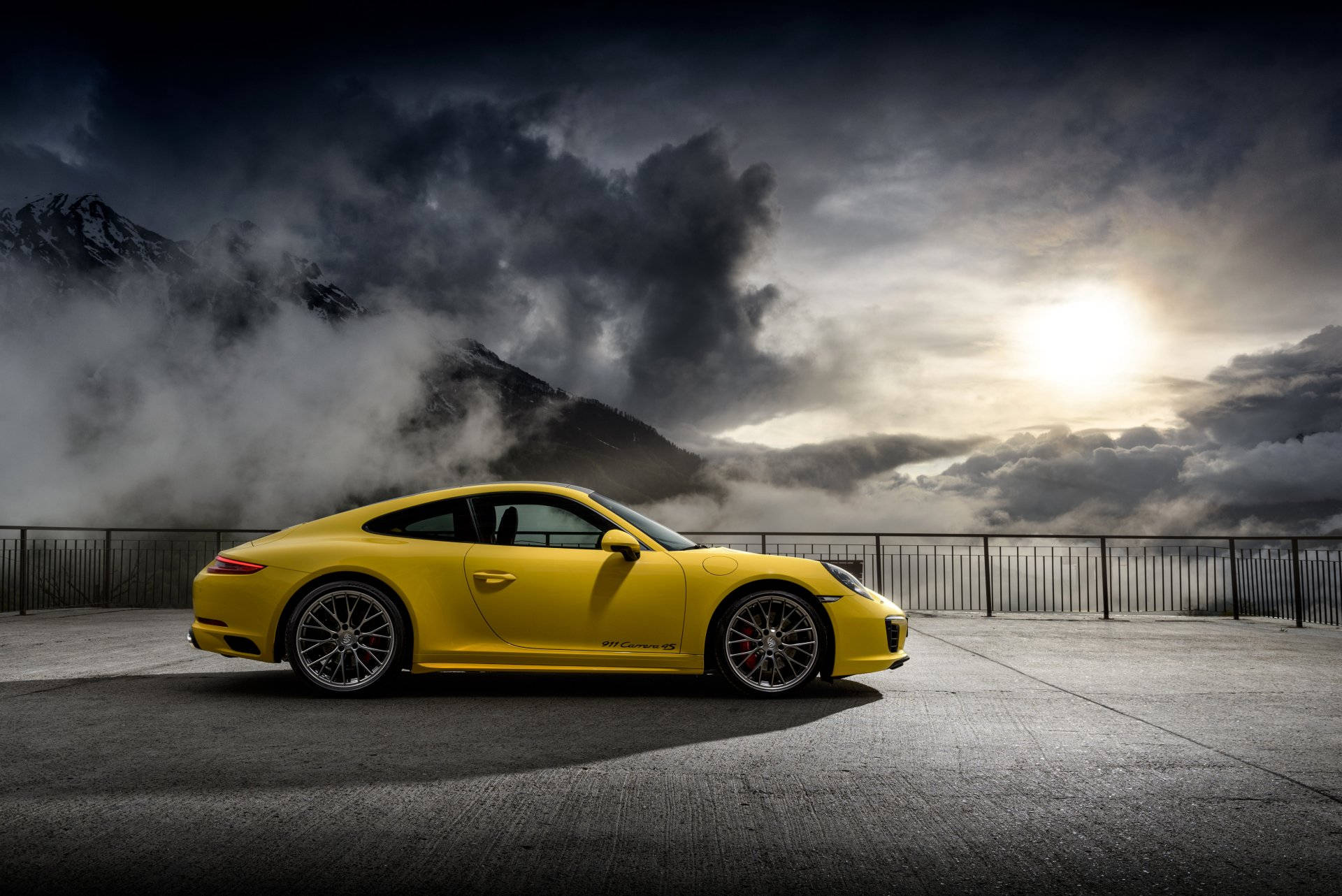 Yellow Porsche 911 Under Cloudy Sky Wallpaper