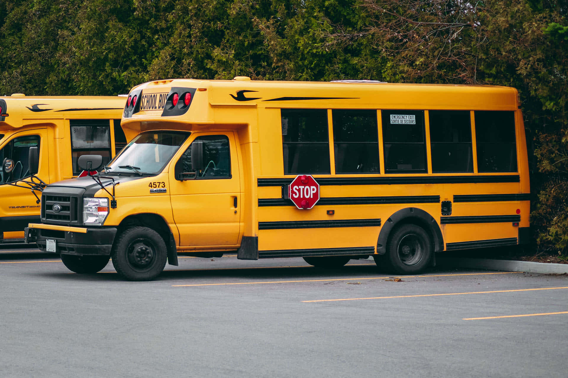 A bright yellow school bus ready to transport students to their destination safely. Wallpaper