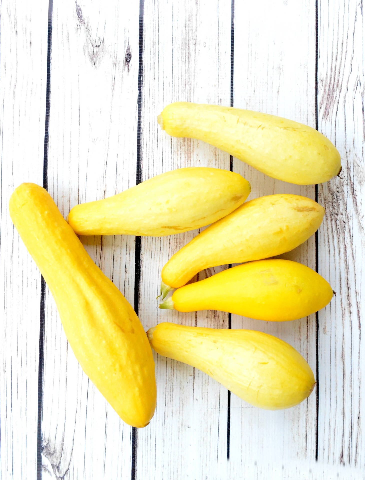 Yellow Squash On A White Wood Surface Wallpaper
