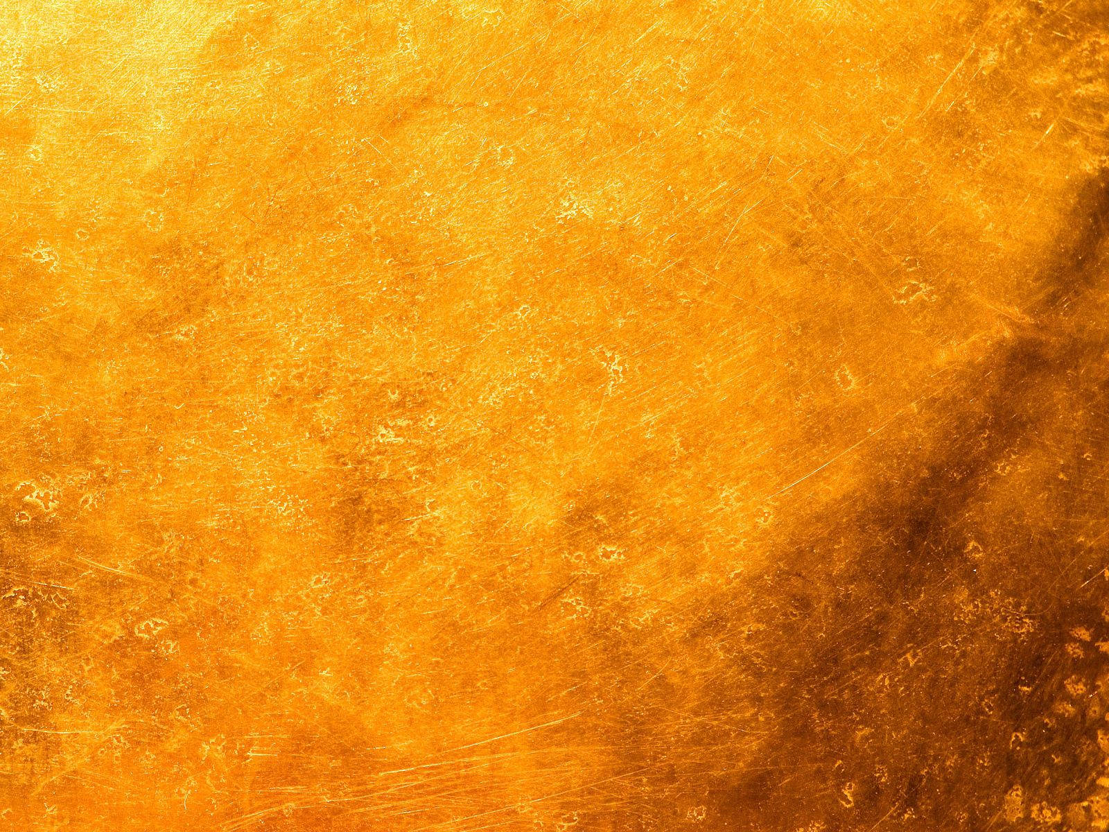 Yellow stains with scratches and spots on textured background.