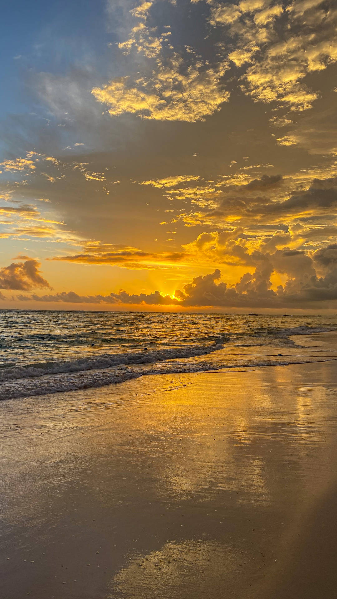 Enjoying a Golden Sunset at the Beach Wallpaper