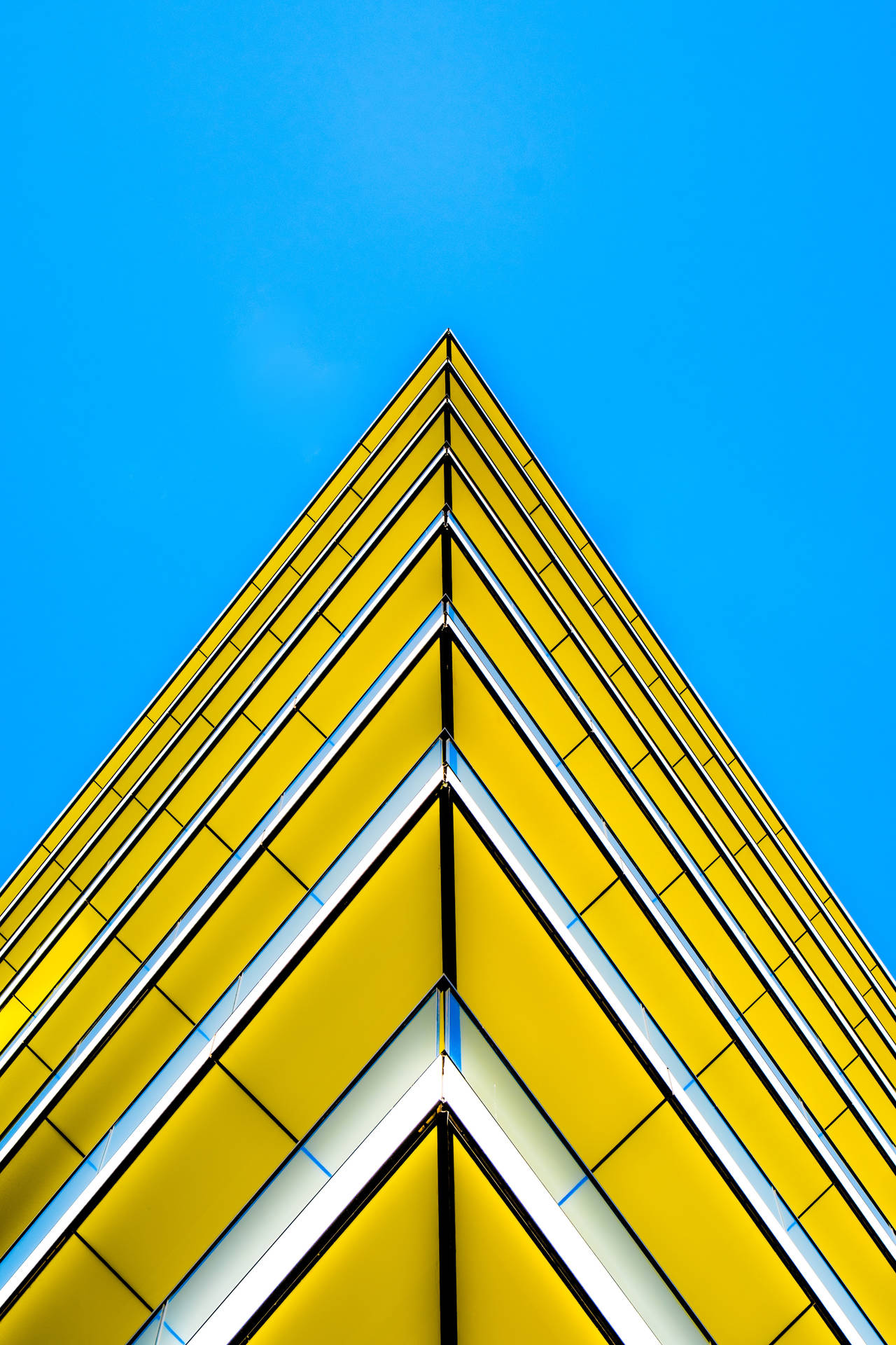 Yellow Triangle Building With Sharp Edges Wallpaper