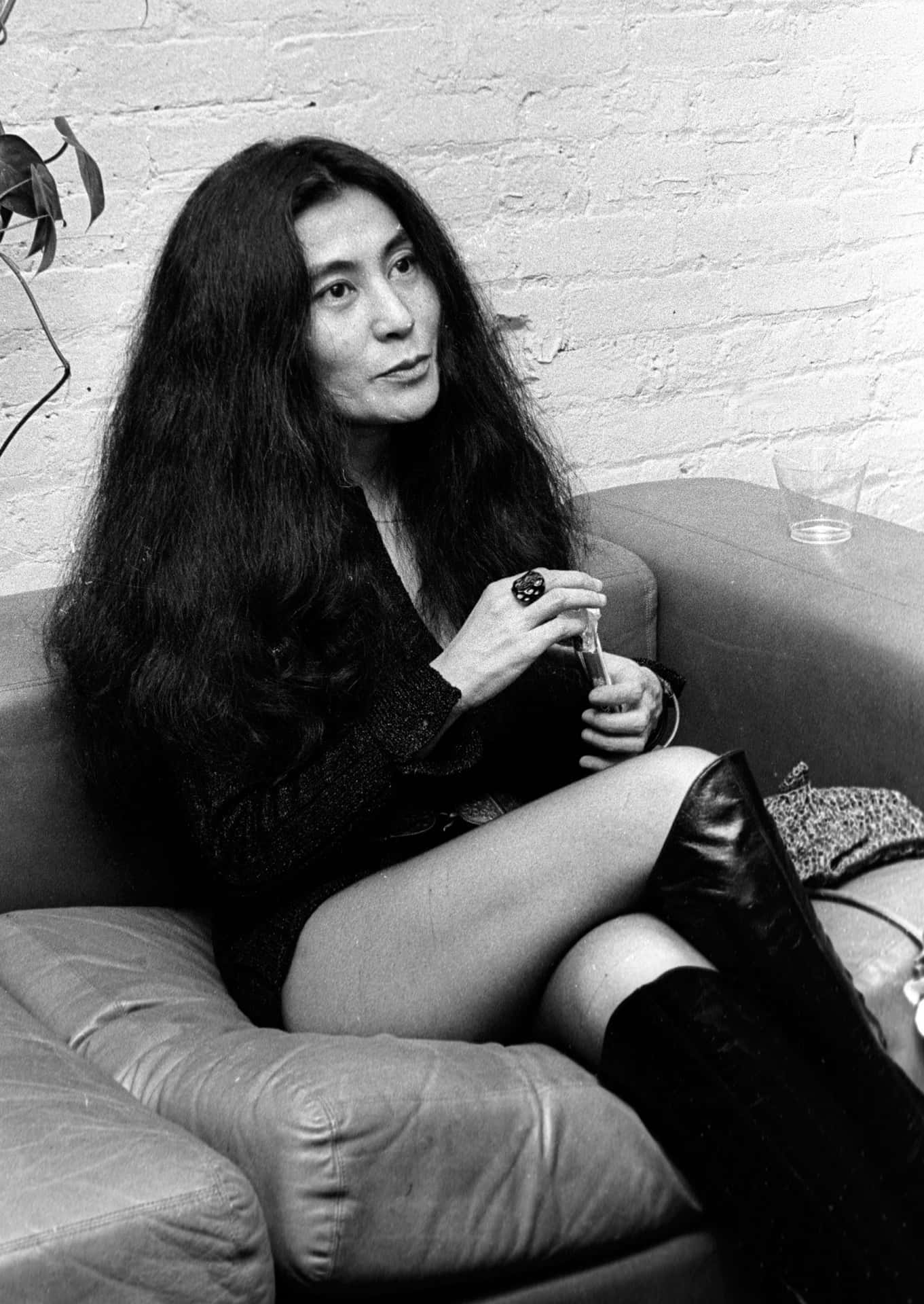 Yoko Ono Sitting On Sofa Wallpaper