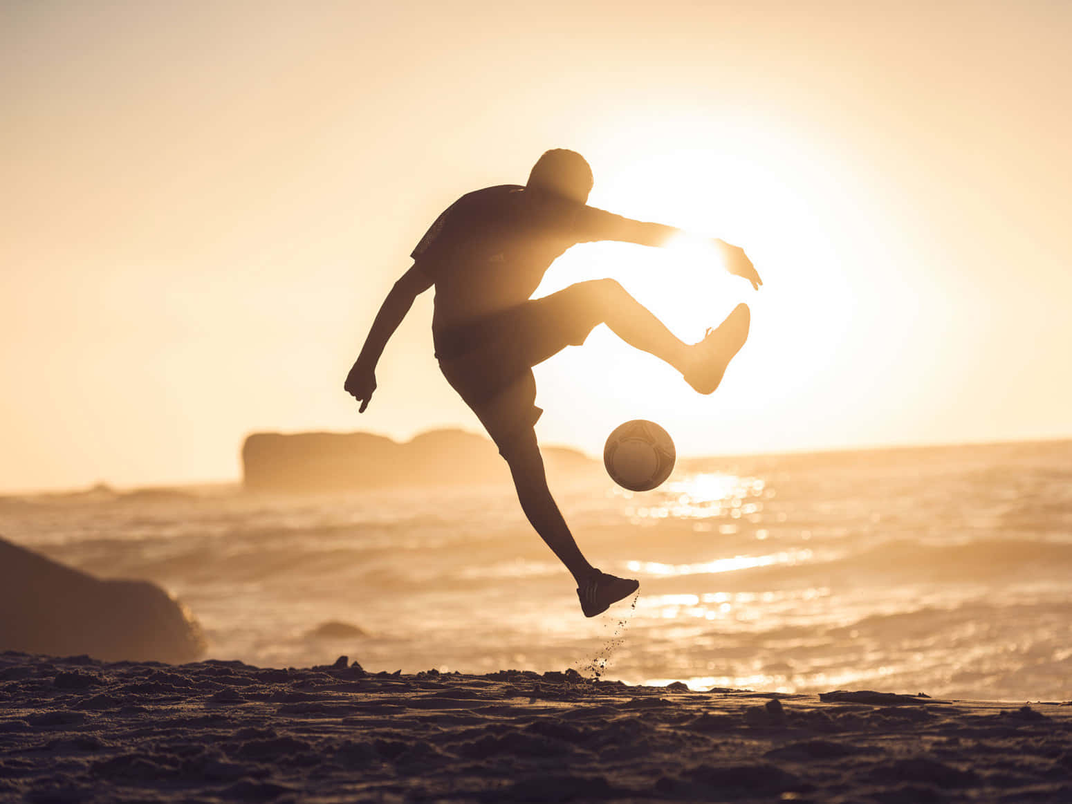 Young Athlete Performing Freestyle Football Tricks Wallpaper