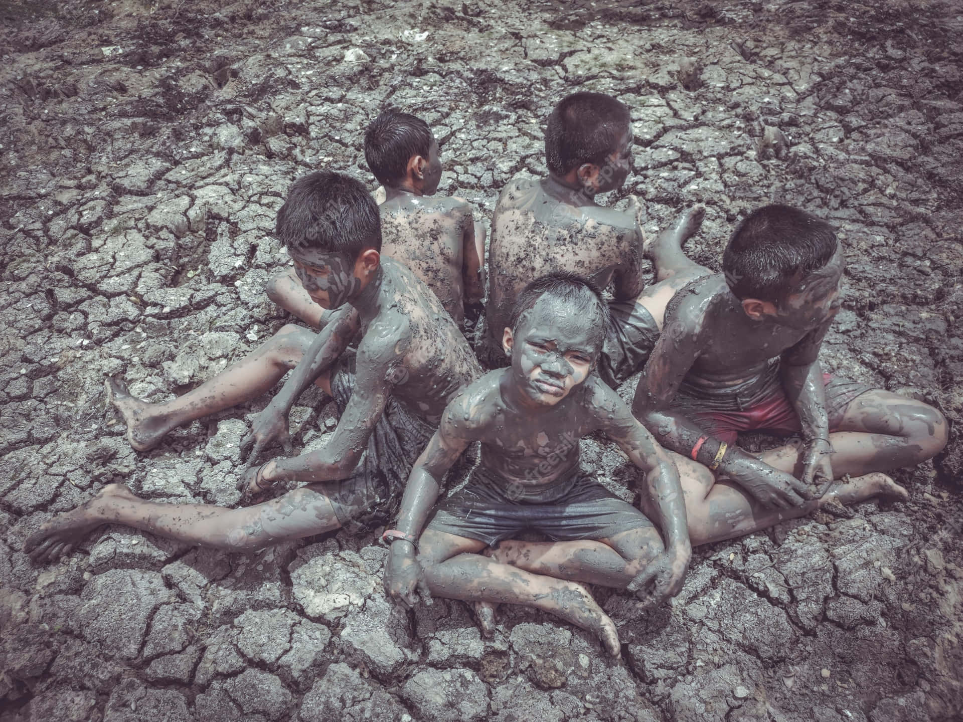Young Boys In Mud In A Local Area In Thailand Wallpaper