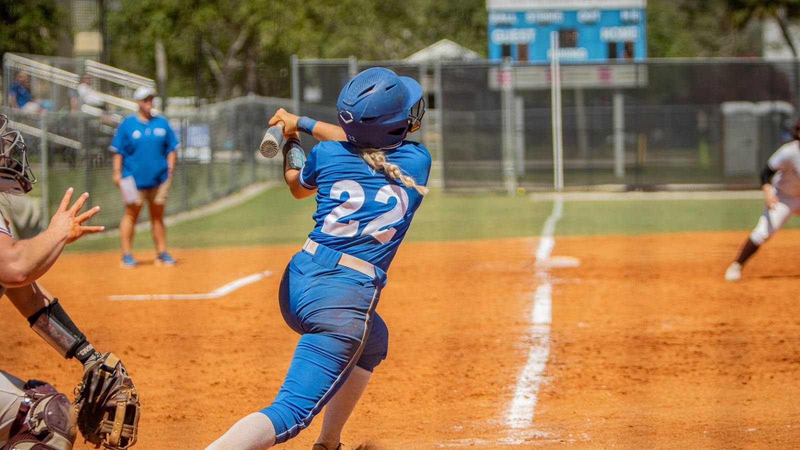 Download Young Female Athlete Swinging For The Fences In A Softball ...