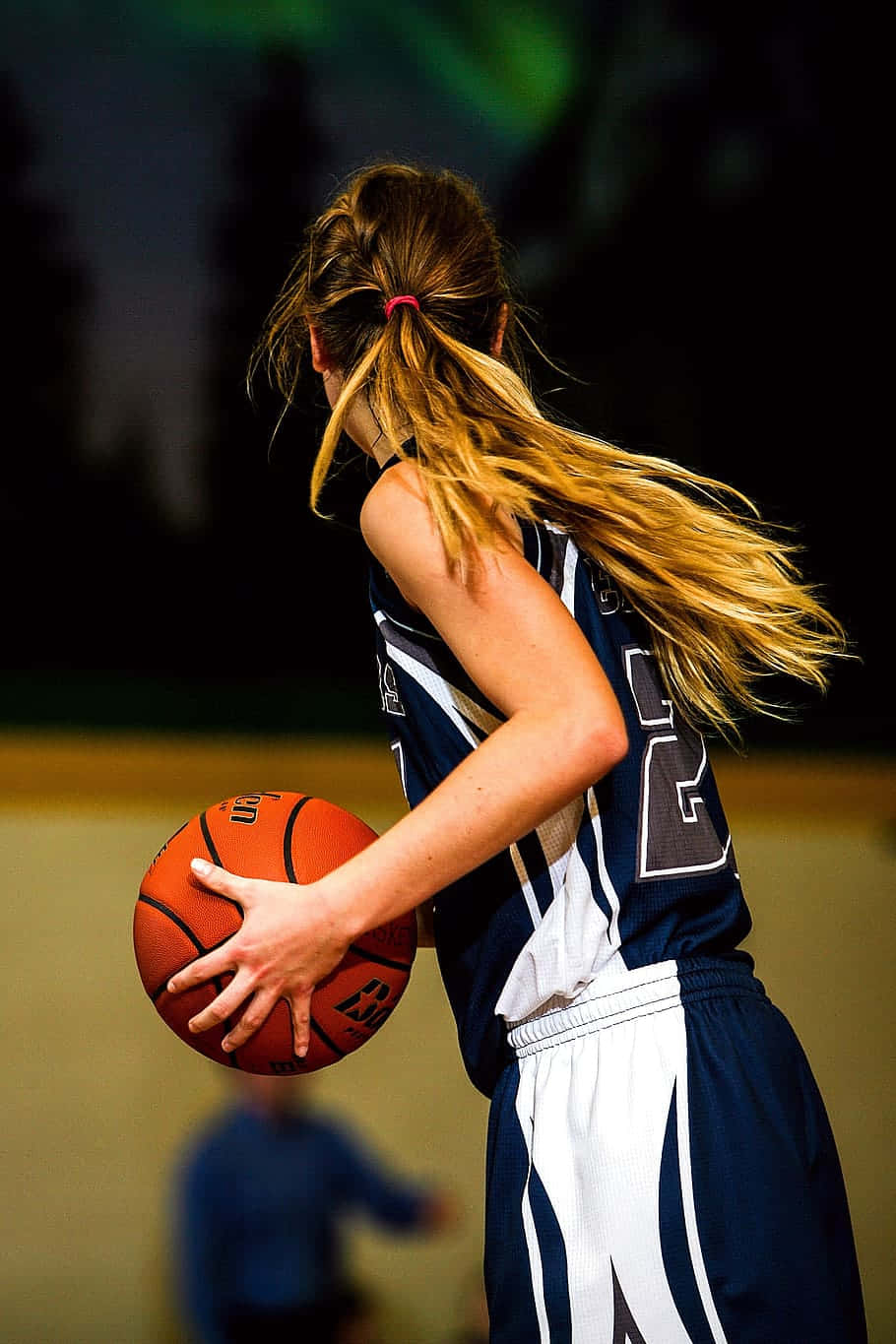 Young Girl Basketball Player Preparation Wallpaper