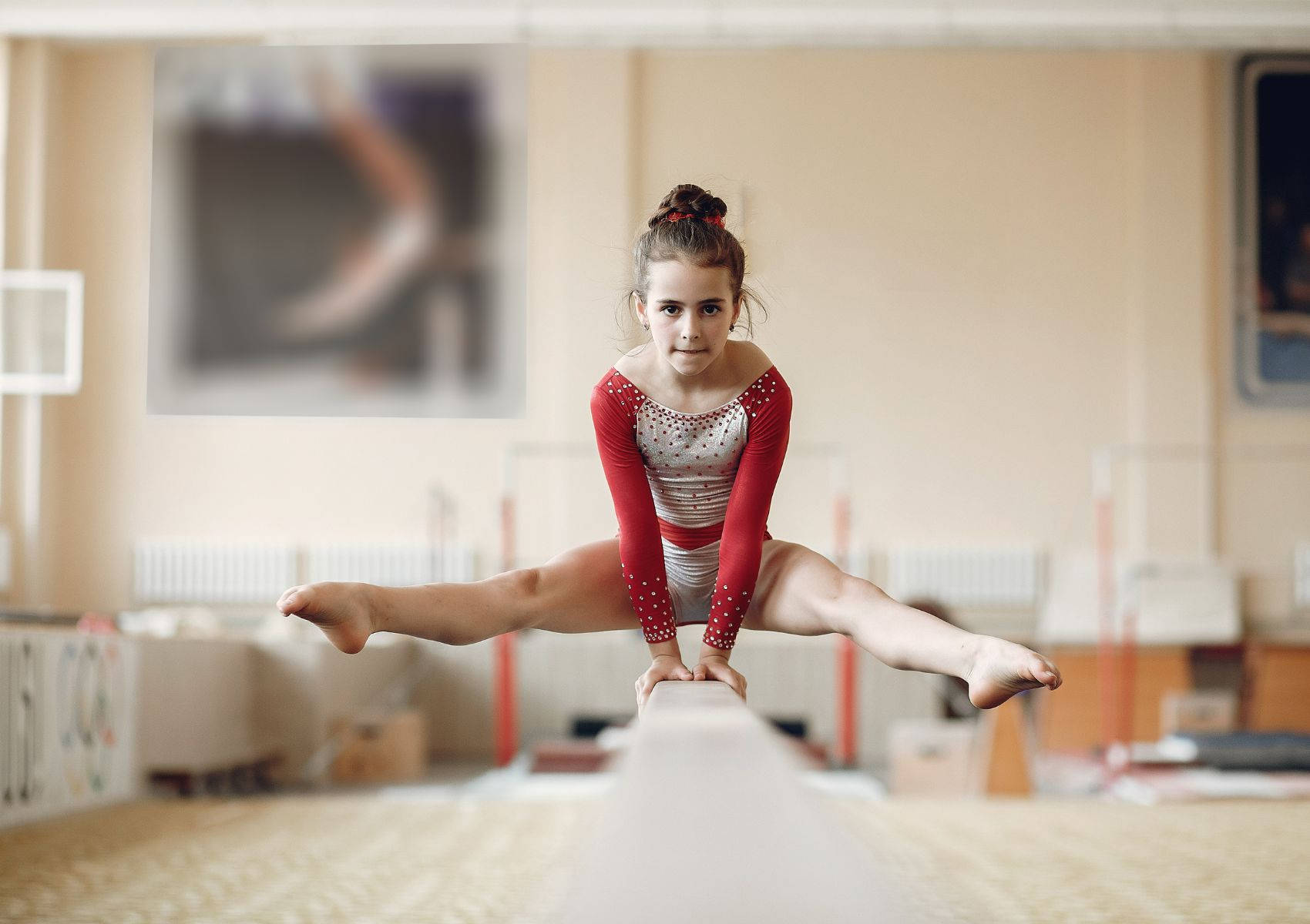 Young Girl Gymnast On The Balance Beam Wallpaper