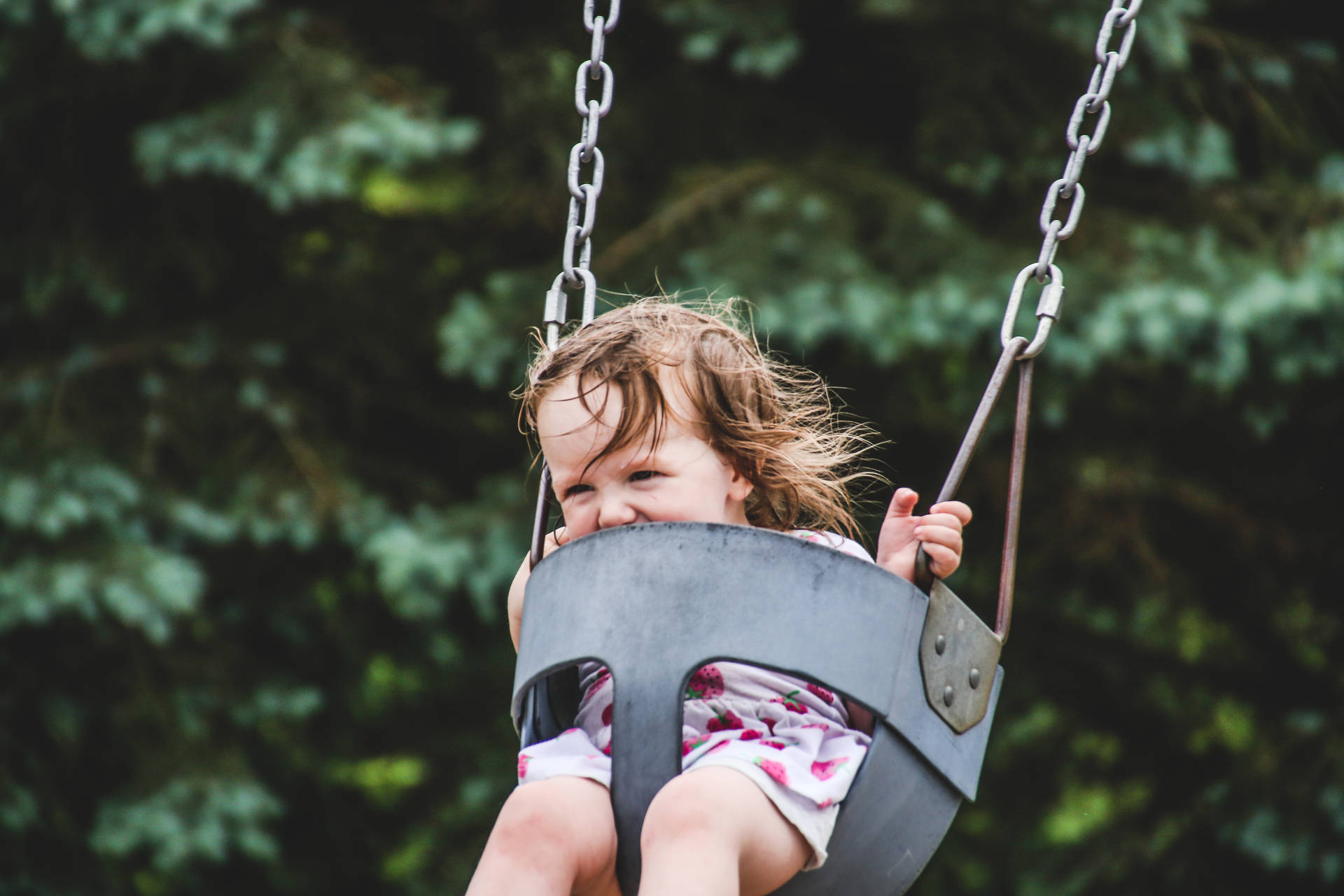 Young Girl On Playground Swing Wallpaper