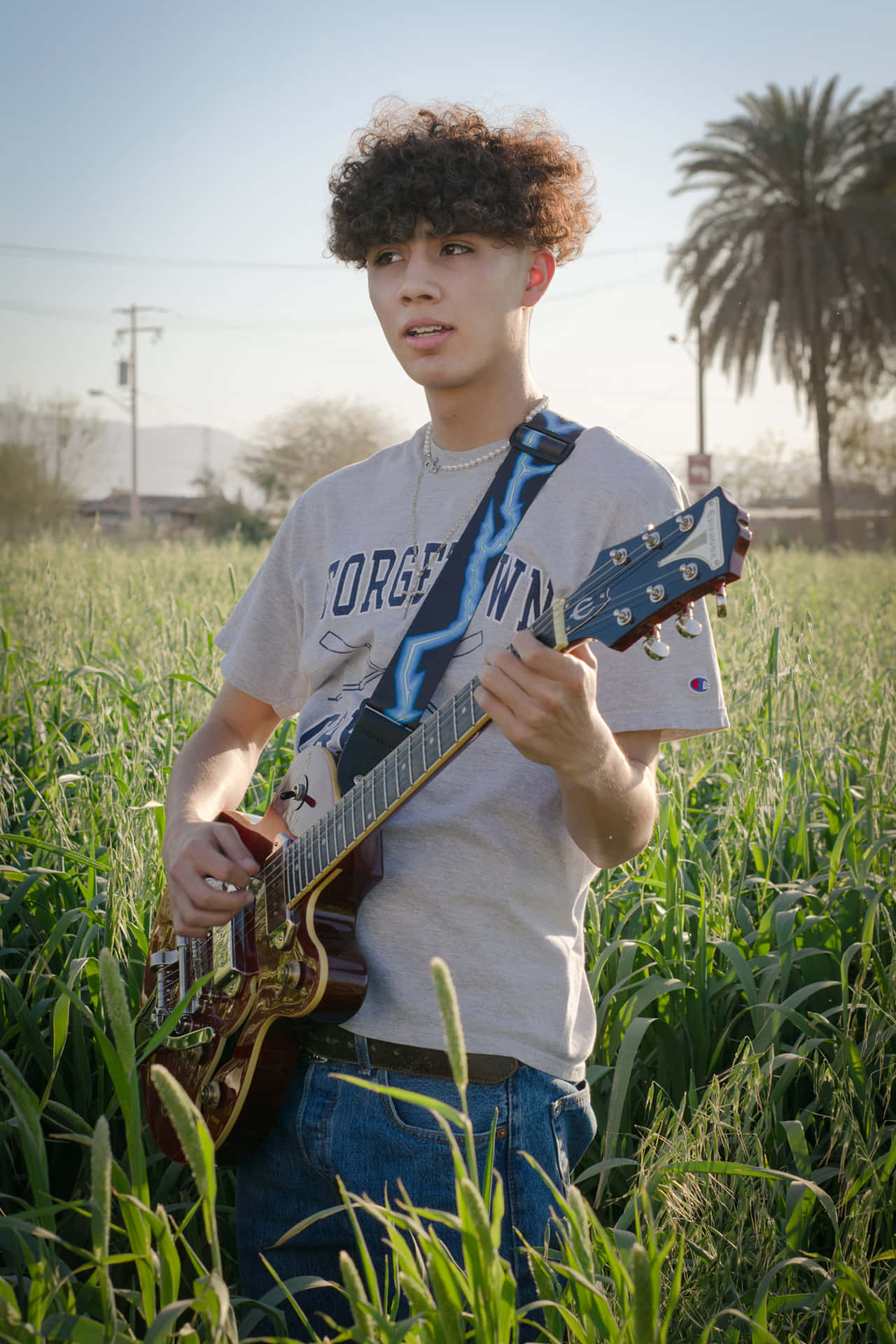 Young Guitarist Field Sunset Wallpaper