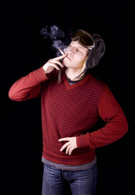 Young Man Smoking In Misty Urban Environment Wallpaper