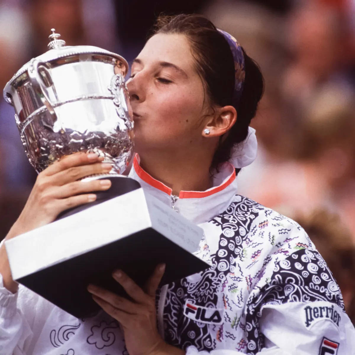 Young Monica Seles Kissing Her Trophy Wallpaper