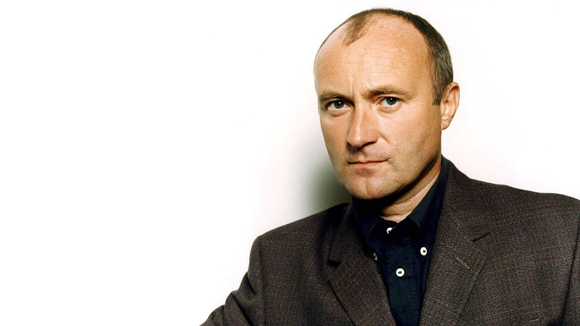 Young Phil Collins Smirking Wallpaper