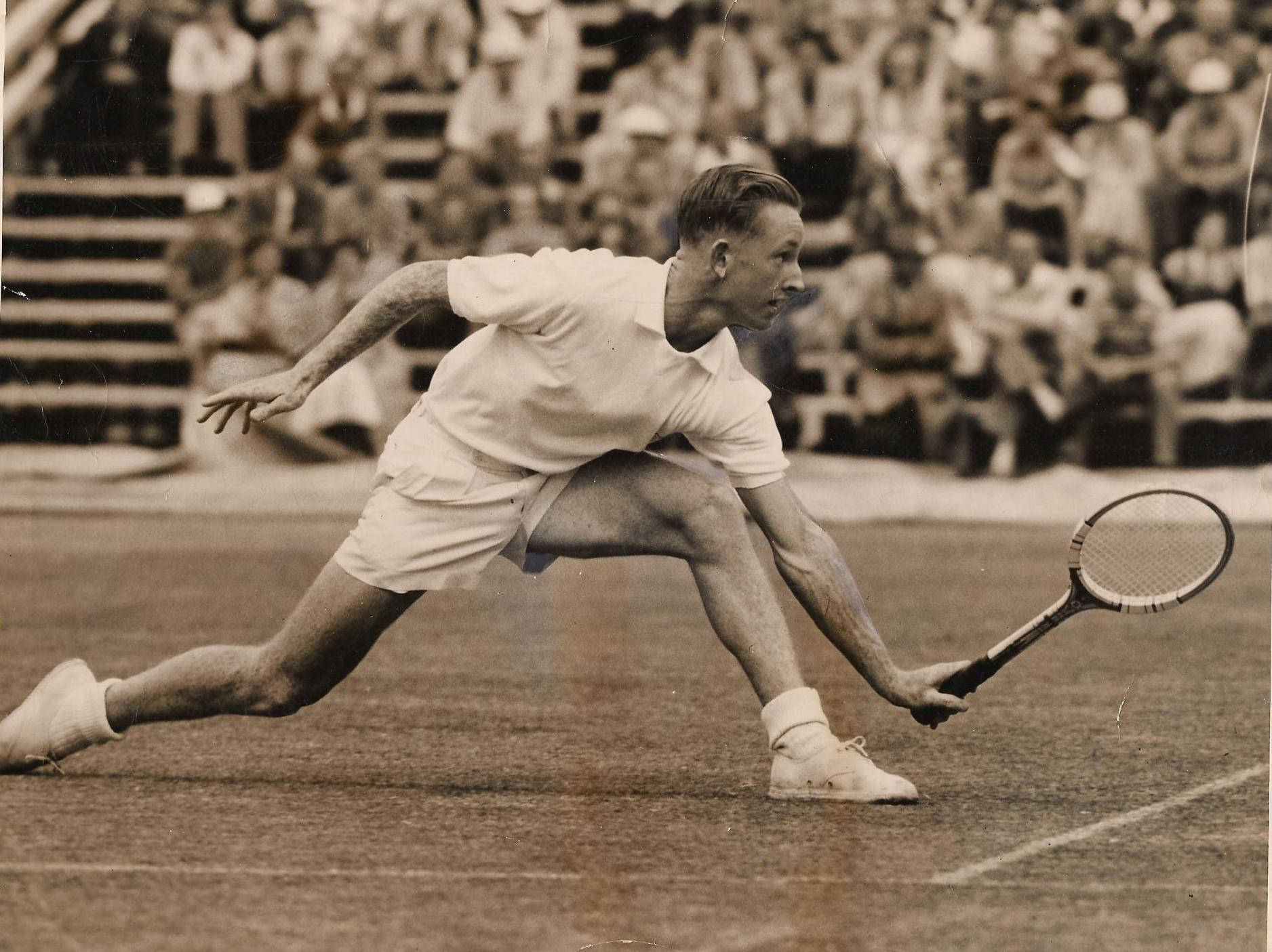 Young Rod Laver Athletic Pose Wallpaper
