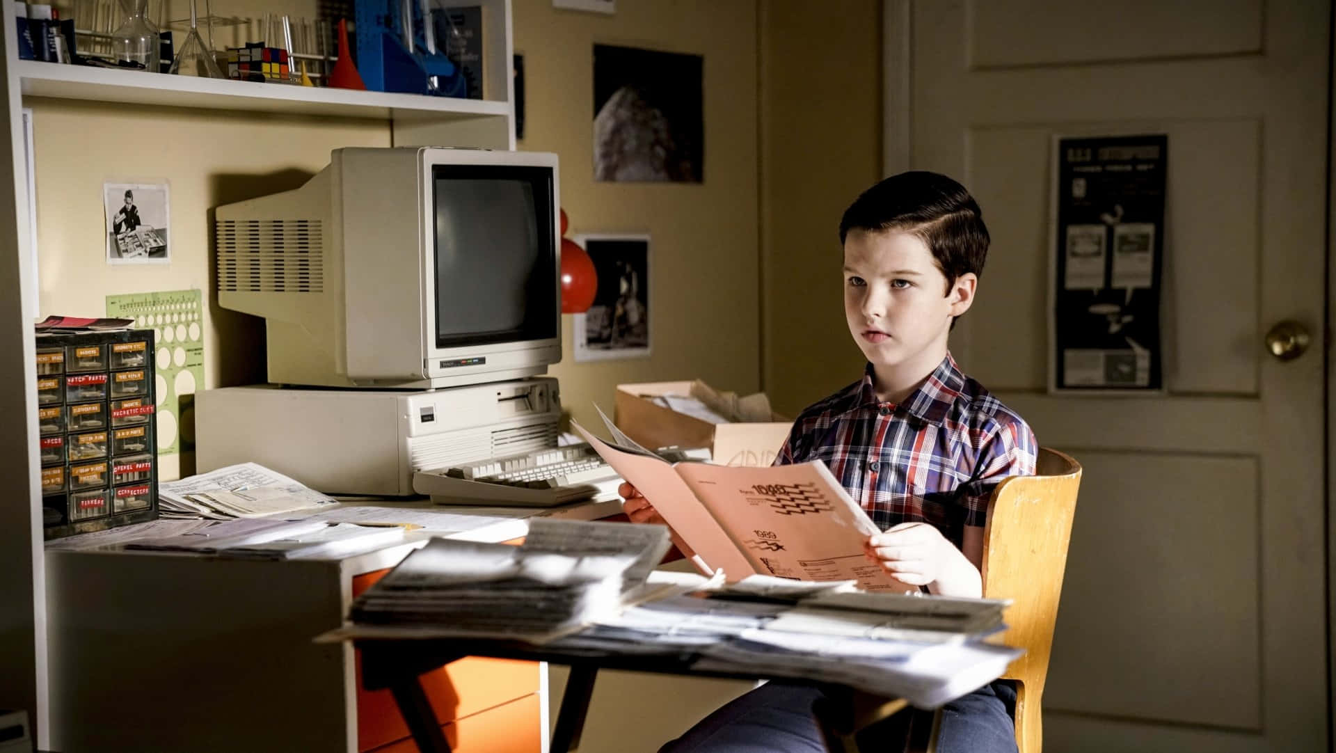 Young Sheldon Studyingat Desk Wallpaper