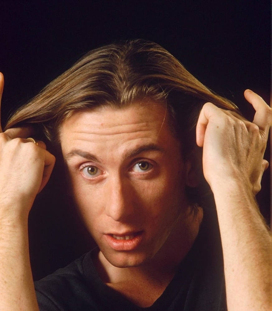 Young Tim Roth Playing With His Hair Wallpaper