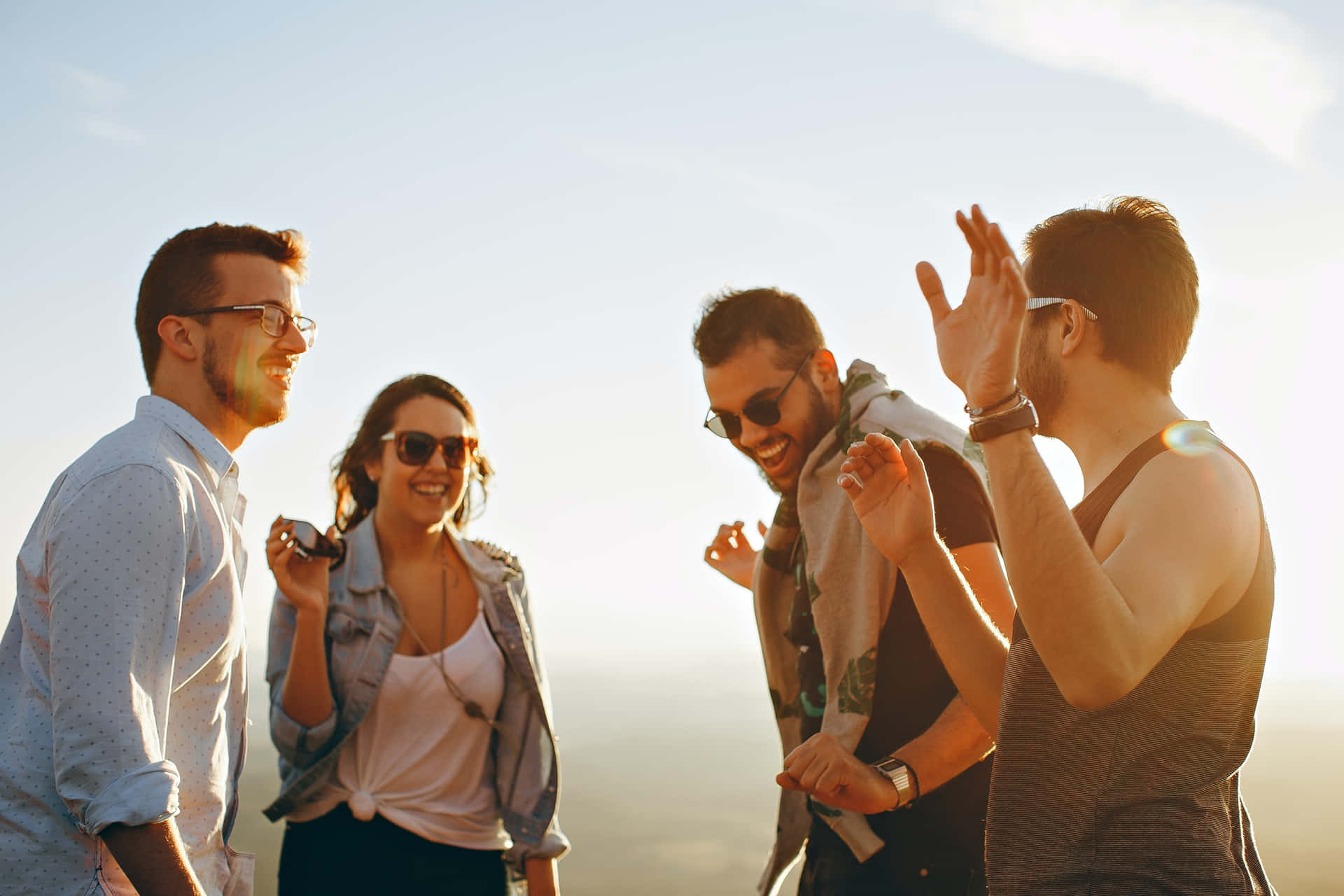 Youth Group Enjoying Sunset Together Wallpaper