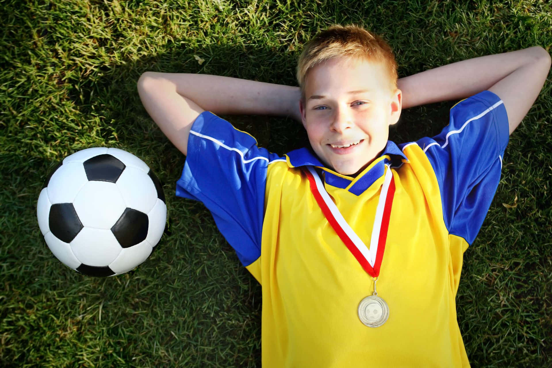 Youth Soccer Player Celebrating Victory Wallpaper