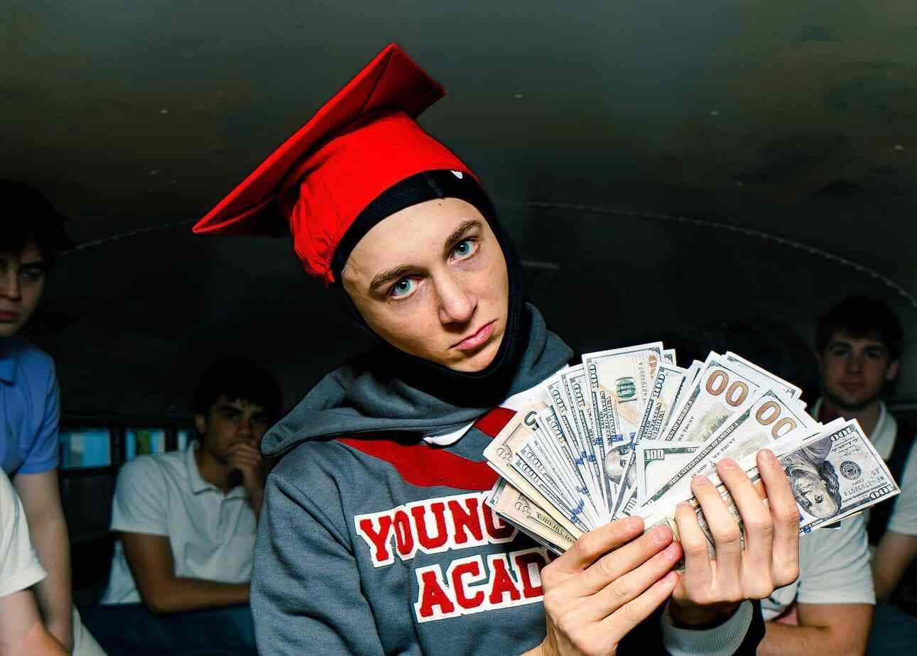 Youth With Cashand Graduation Cap Wallpaper