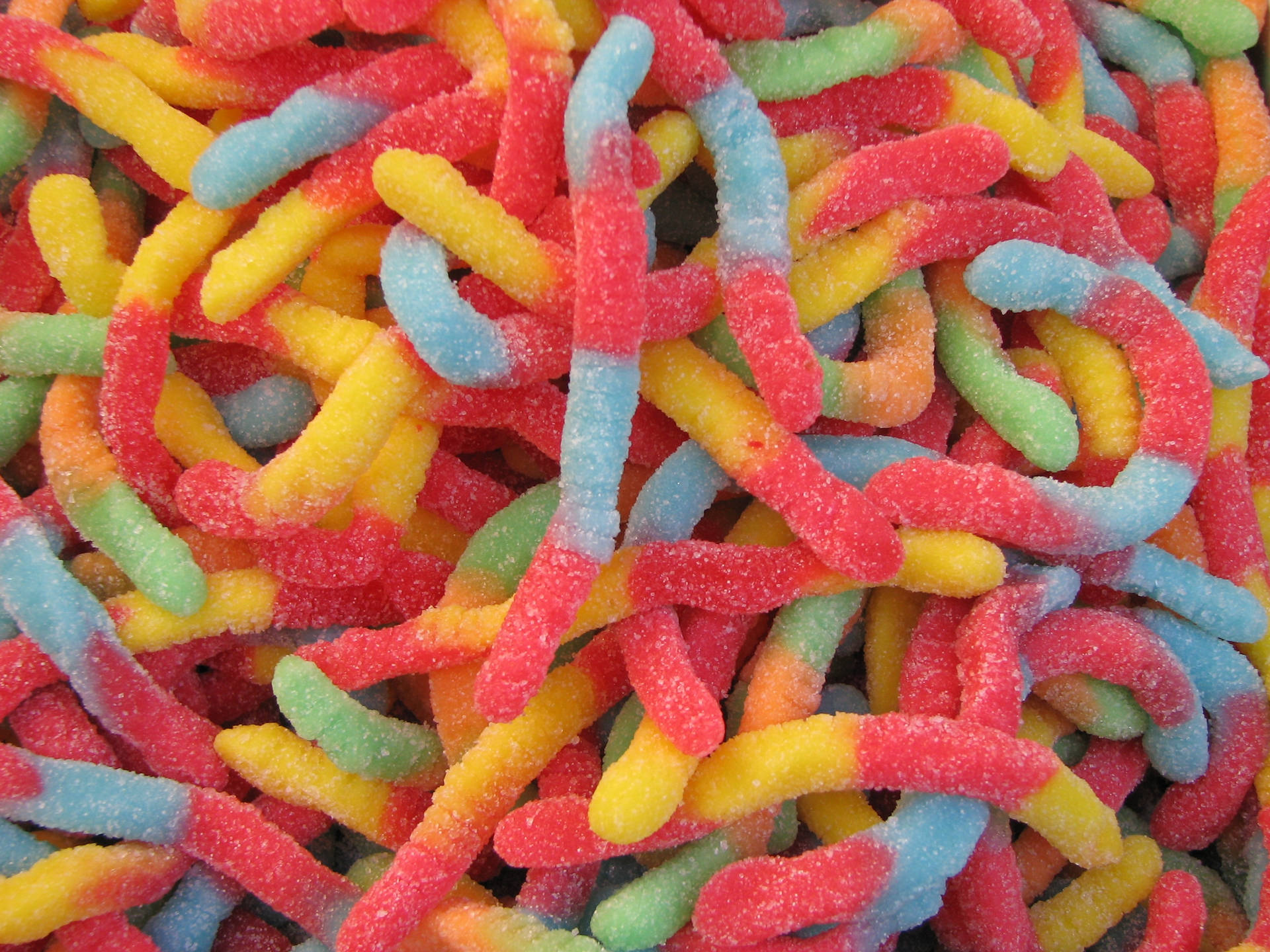 Colorful Feast of Gummy Worm Candies Wallpaper